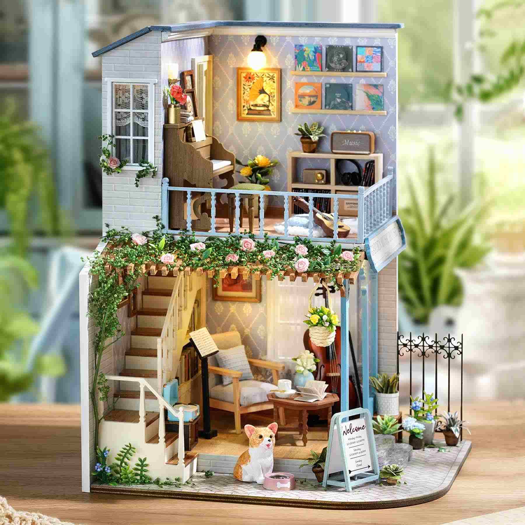Miniature model of a house with interior details and decorative elements.