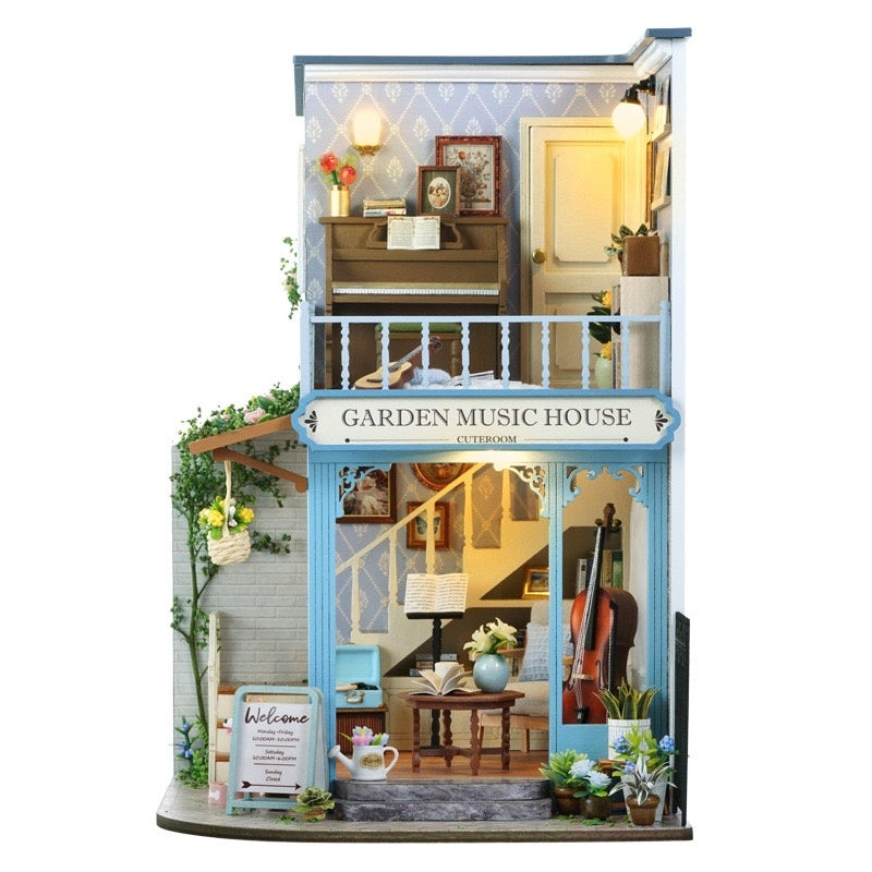 Miniature house of a 'Garden Music House' with interior details on a white background