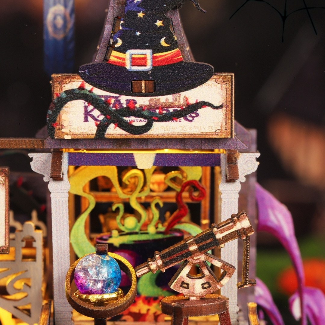 magic-themed decorative miniature item with a witch hat, crystal ball, and telescope.