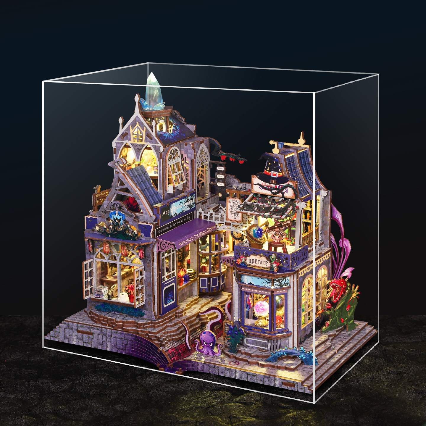 Detailed magic house model of a building in a clear display case with a dark background