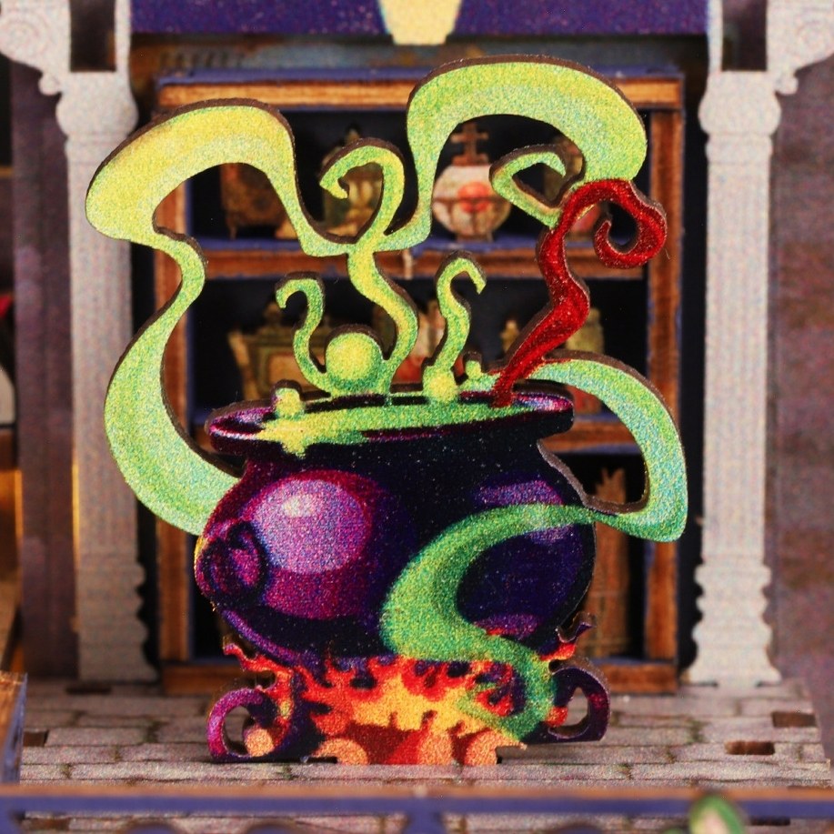 Decorative miniature cauldron with wavy designs on a colorful background