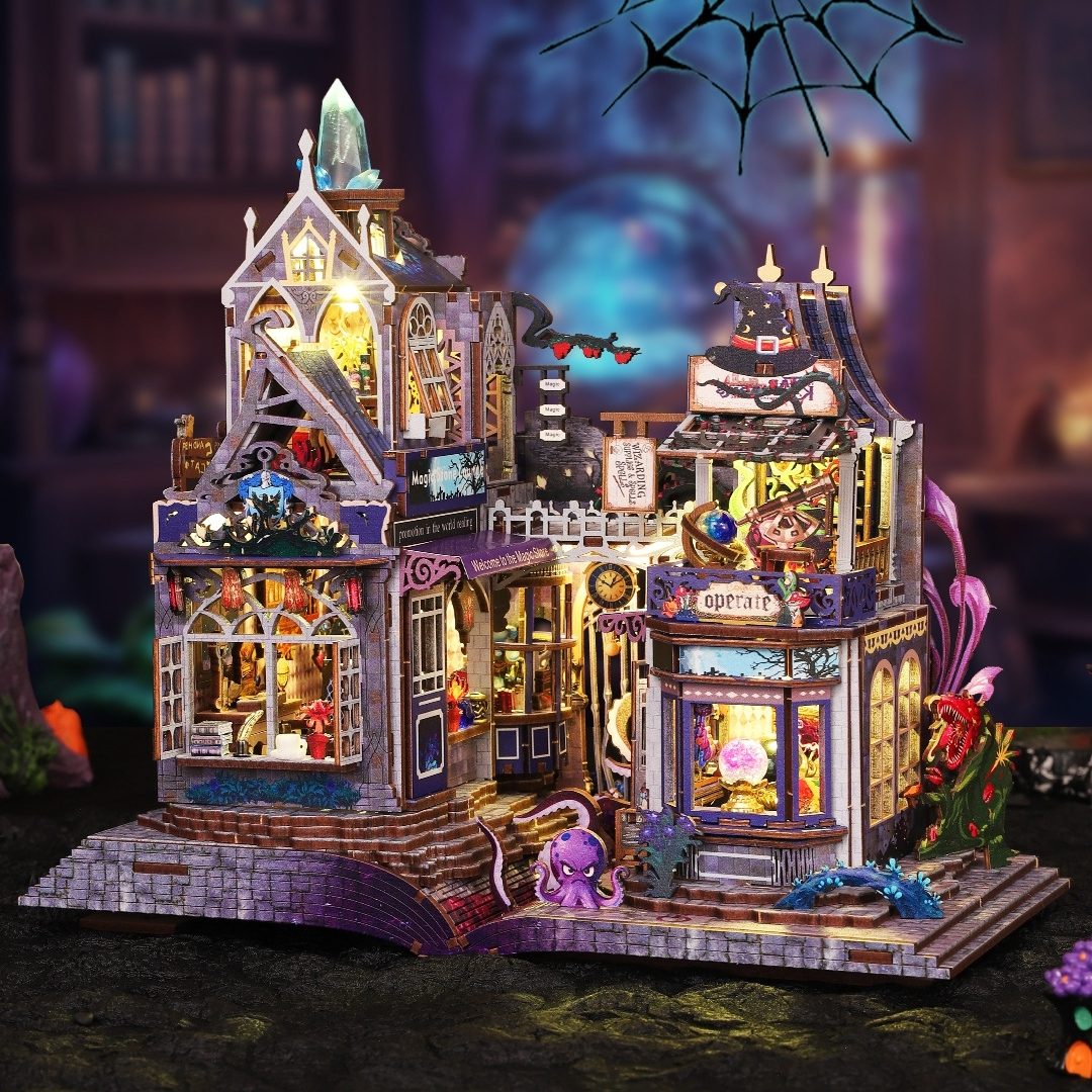 Detailed miniature model of a haunted magic house with various decorations and lights, set against a dark background.