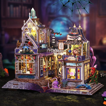 Detailed miniature model of a haunted magic house with various decorations and lights, set against a dark background.