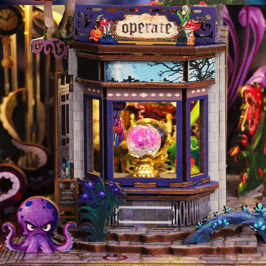 Detailed miniature model of a haunted magic house with a crystal ball and octopus figure.