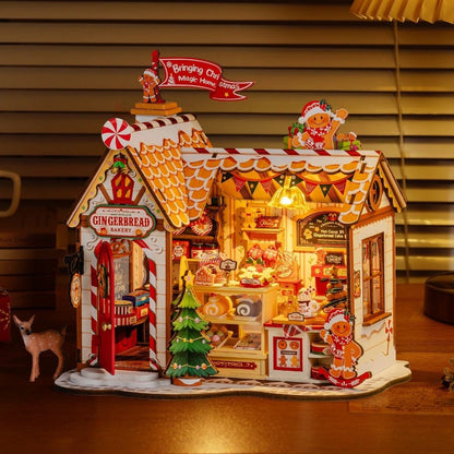 Gingerbread-themed bakery miniature house with lights on a wooden floor