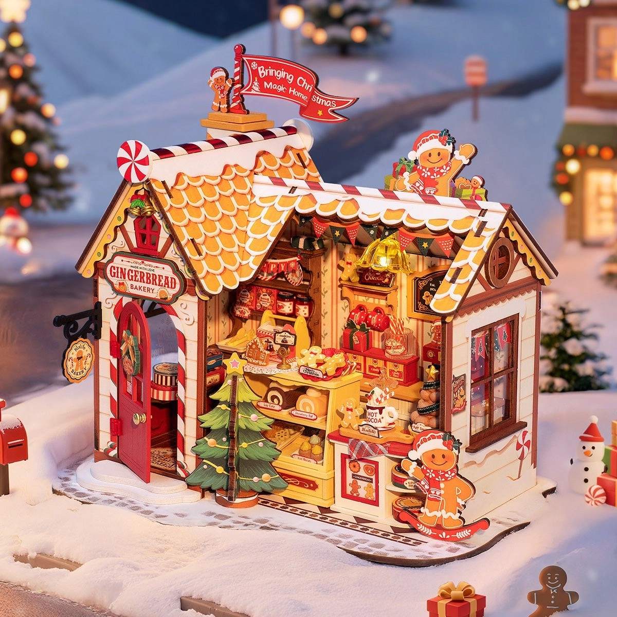 Gingerbread house model with decorative elements on a snowy background