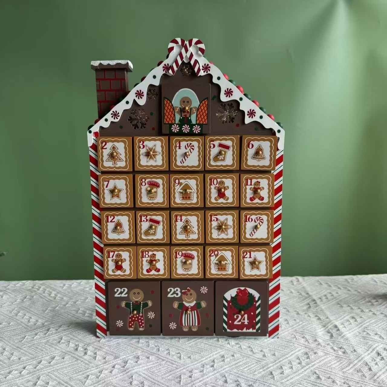 front side of Gingerbread House Wooden Advent Calendar on table