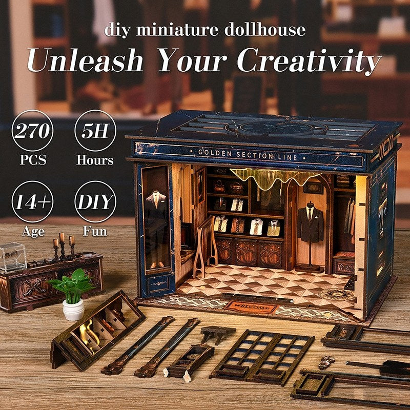 tailor shop themed DIY miniature dollhouse kit with components and text 'Unleash Your Creativity' on a wooden surface.