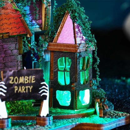 Halloween-themed miniature haunted house with zombie hand holding a 'Zombie Party' sign, illuminated with green lights.