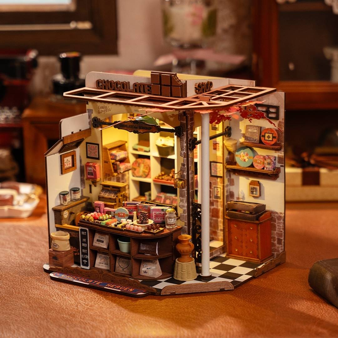 Miniature model of Henry's Chocolate store with various items on table