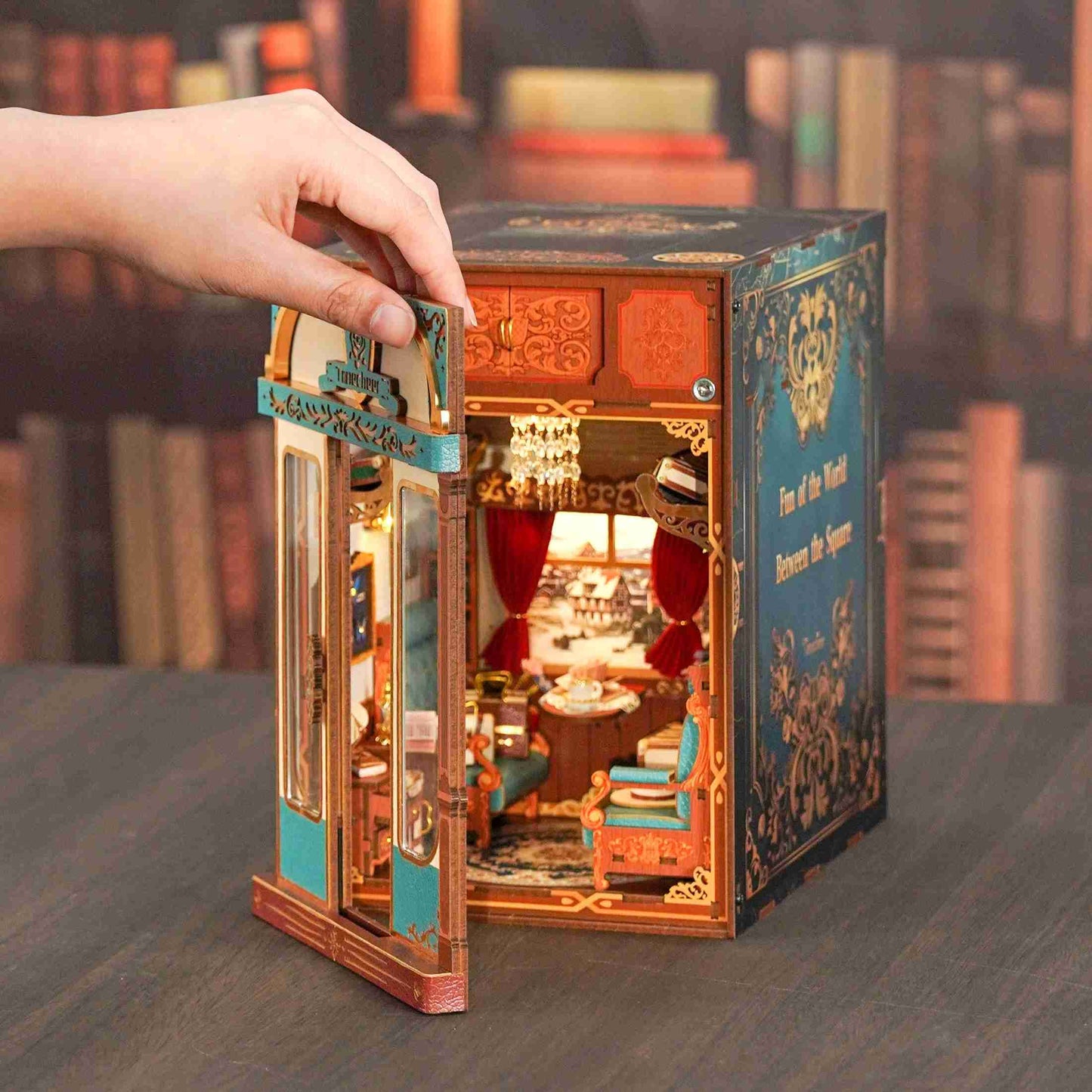 image showcasing the door of Infinity Train Cabin DIY Book Nook Kit opened by hand