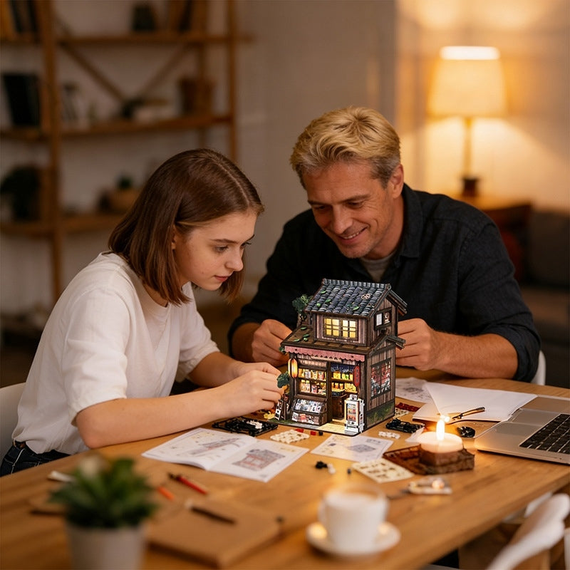 Man and woman working on a puzzle of a Japanese grocery store together at a table.