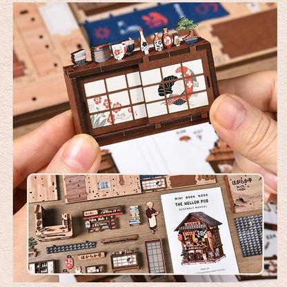 Miniature model of a Japanese Izakaya on a miniature set held by a hand