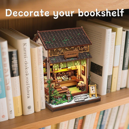 Miniature model of a traditional Japanese tea house on a bookshelf with text 'Decorate your bookshelf'.