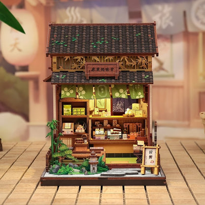 Detailed dollhouse model of a traditional Japanese tea house on a wooden surface.