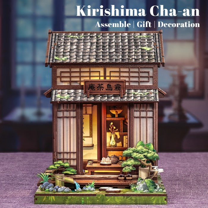 Miniature House Model of a traditional Japanese tea house with 'Kirishima Cha-an' branding on a blurred background.