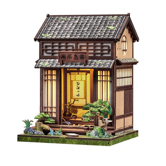 Miniature House Model of a traditional Japanese tea house with illuminated interior on a white background