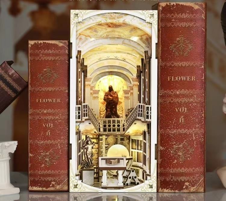Library of Gods DIY Book Nook Kit, a miniature replica of the Admont Abbey library, featuring towering shelves filled with tiny books, a huge statue of a god, a crystal globe, and seven vaulted domes with frescoes. Perfect for bookshelf decor, and dollhouse collectors, or a gift for art lovers, history fans and DIY enthusiasts - front side