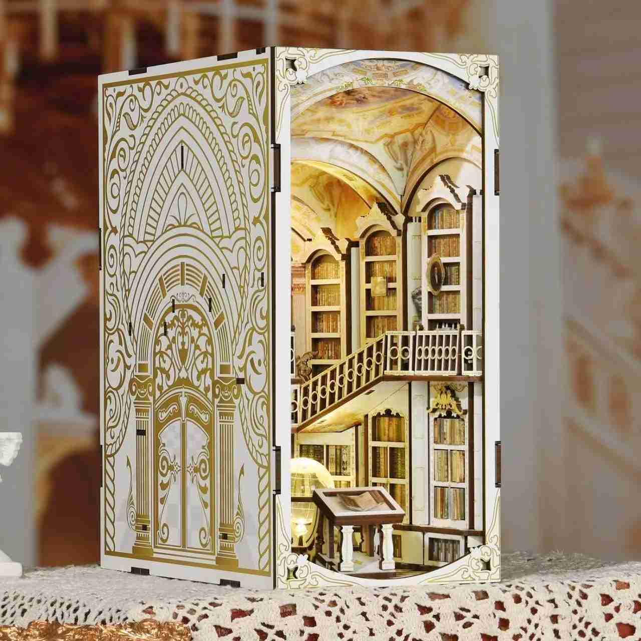 Library of Gods DIY Book Nook Kit, a miniature replica of the Admont Abbey library, featuring towering shelves filled with tiny books, a huge statue of a god, a crystal globe, and seven vaulted domes with frescoes. Perfect for bookshelf decor, and dollhouse collectors, or a gift for art lovers, history fans and DIY enthusiasts - left angle