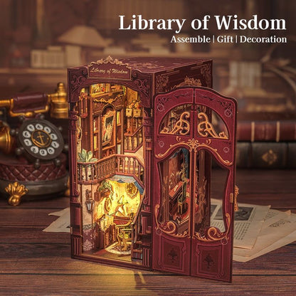 image displaying the assembled Library of Wisdom DIY Book Nook Kit with warm light on in a table setting