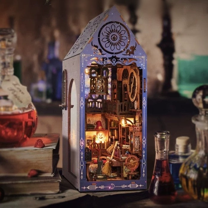 image display a completed Magic Academy DIY Book Nook on a table setting，magic potions are sitting next to each other，showcasing the magical atmosphere that this book nook brings