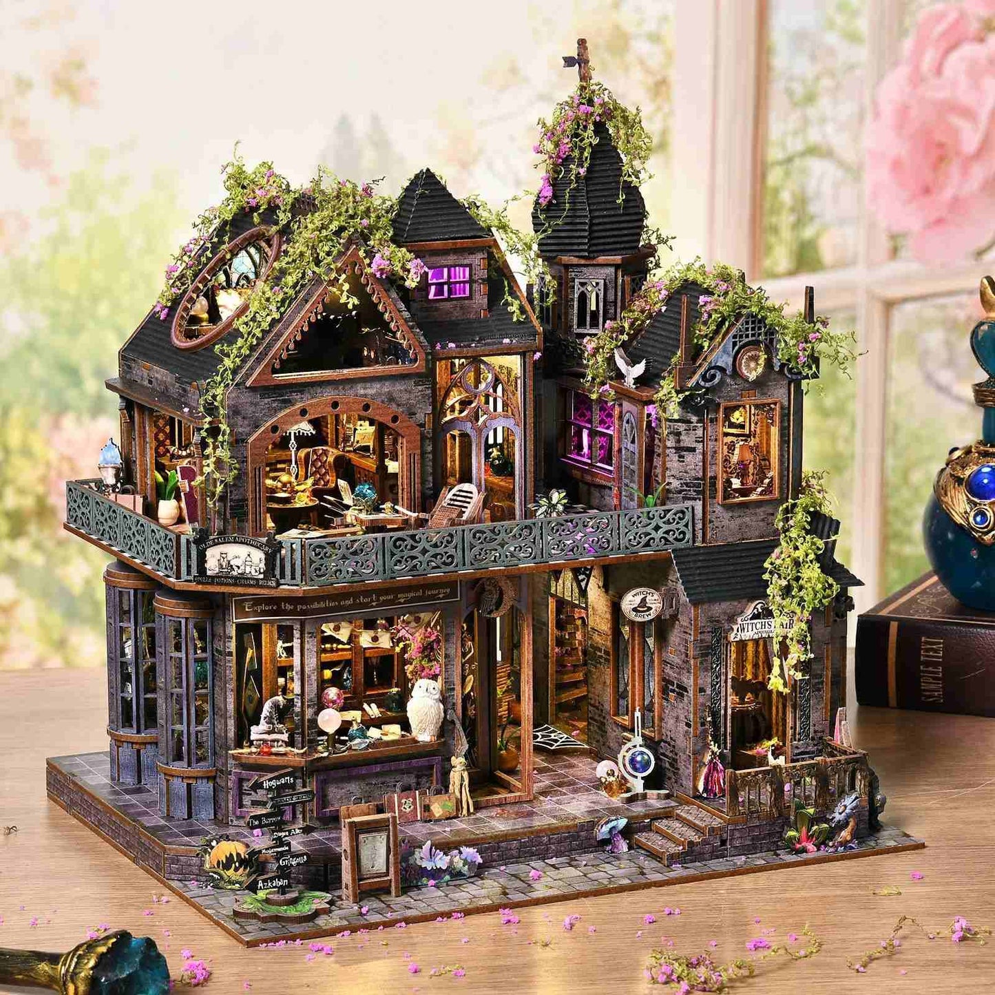 Detailed model of a magic house with decorative elements on a wooden surface.