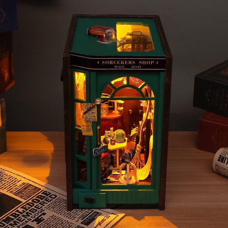 image displaying the finished Magic Diary DIY Book Nook Kit with warm LED light in a table setting