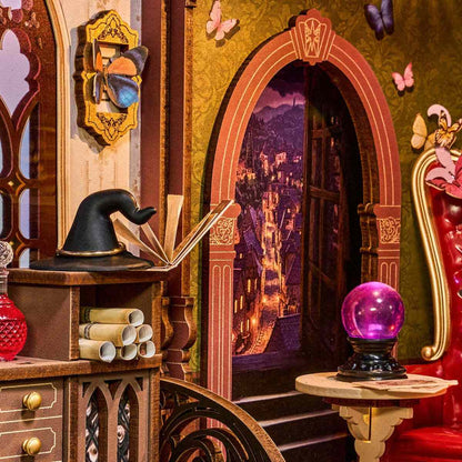 miniature interior with a book, hat, and purple crystal ball in a fantasy setting.