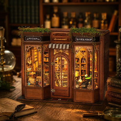 A miniature wooden potion and workshop shop model with glowing warm interior lights, greenery on top, and detailed shelves, displayed on a wooden surface with a blurred bookshelf background.
