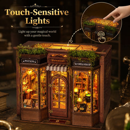 A miniature wooden shop model with glowing warm interior lights, labeled 'Potion' and 'Workshop,' shown on a dark tabletop. Text at the top reads 'Touch-Sensitive Lights,' and a circular inset shows a finger touching the roof light panel to activate it.