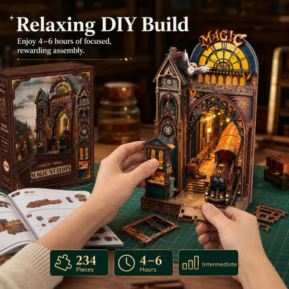 A person's hands are assembling a 3D papercraft model of a 'Magic Station' train station. The image includes the product box, an open instruction booklet, and informational text overlays highlighting that the build is relaxing and takes 4-6 hours.