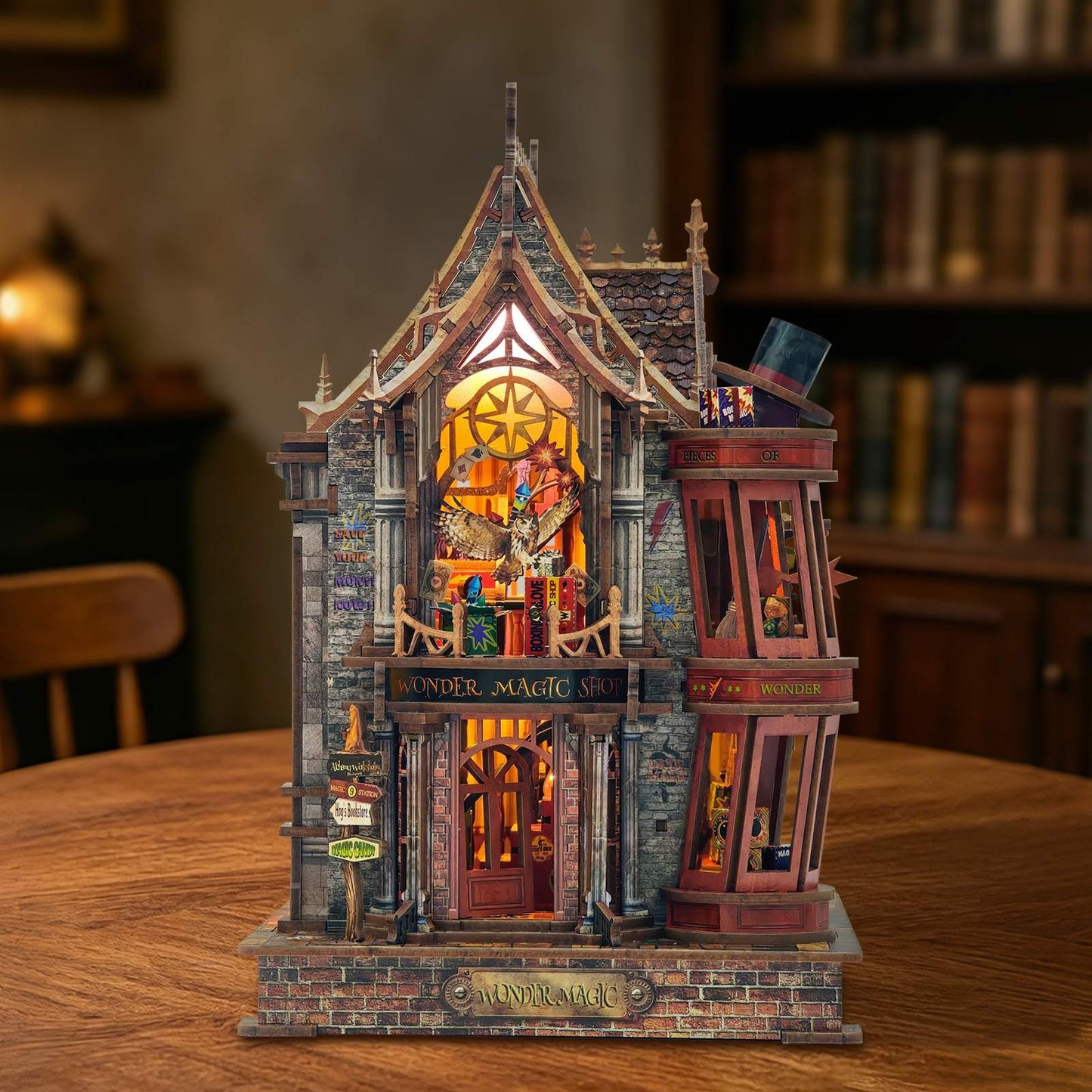 Detailed miniature house model of a fantasy building with illuminated interior on a wooden table.