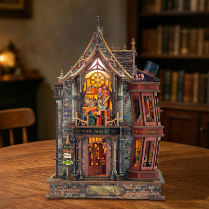 Detailed miniature house model of a fantasy building with illuminated interior on a wooden table.