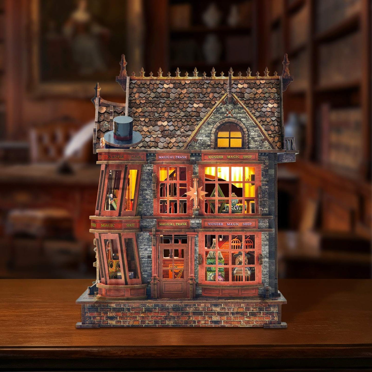 Detailed miniature house model of a vintage building with illuminated windows on a wooden surface.