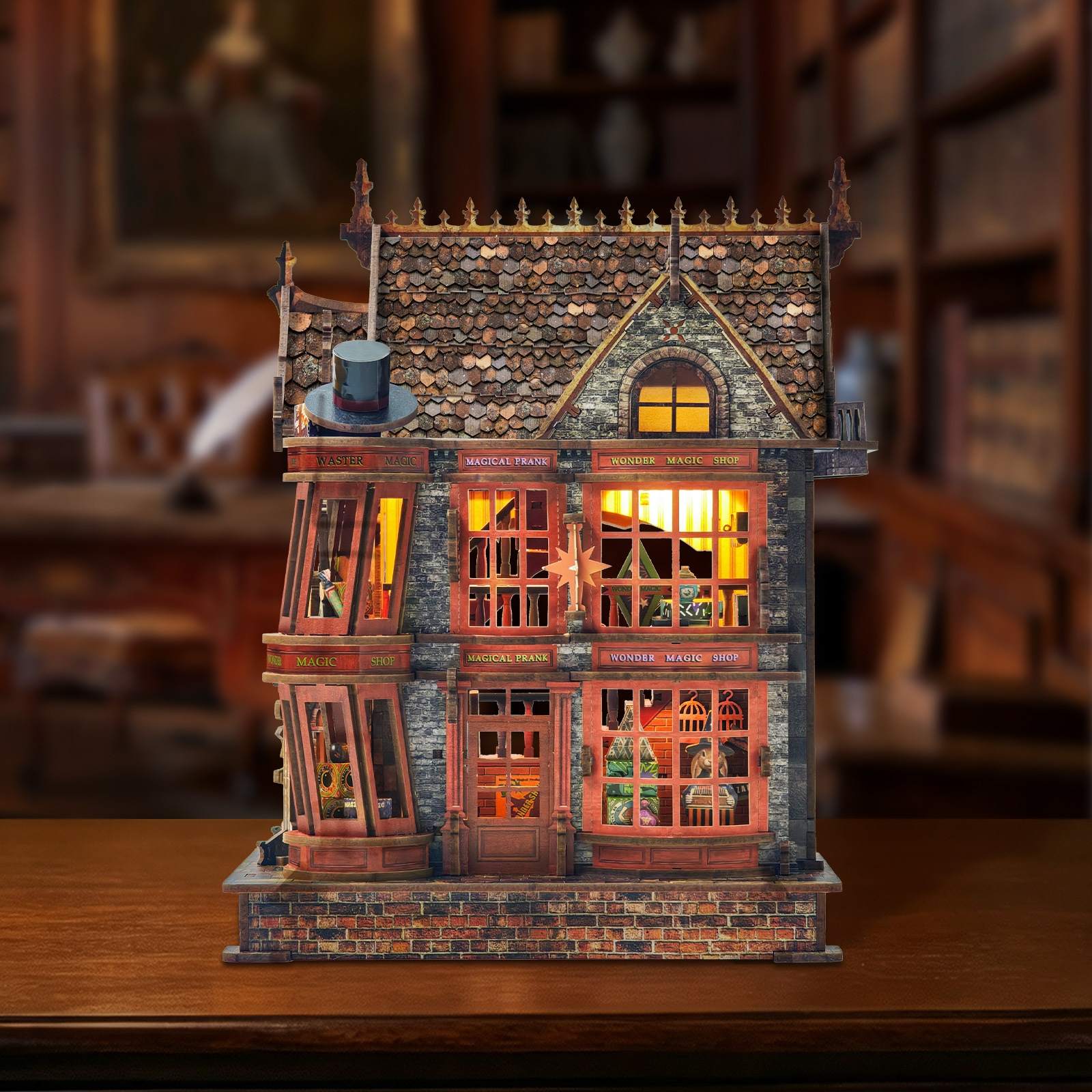 Detailed miniature house model of a vintage building with illuminated windows on a wooden surface.