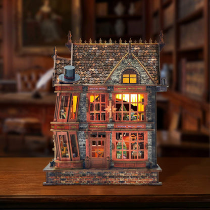 Detailed miniature house model of a vintage building with illuminated windows on a wooden surface.