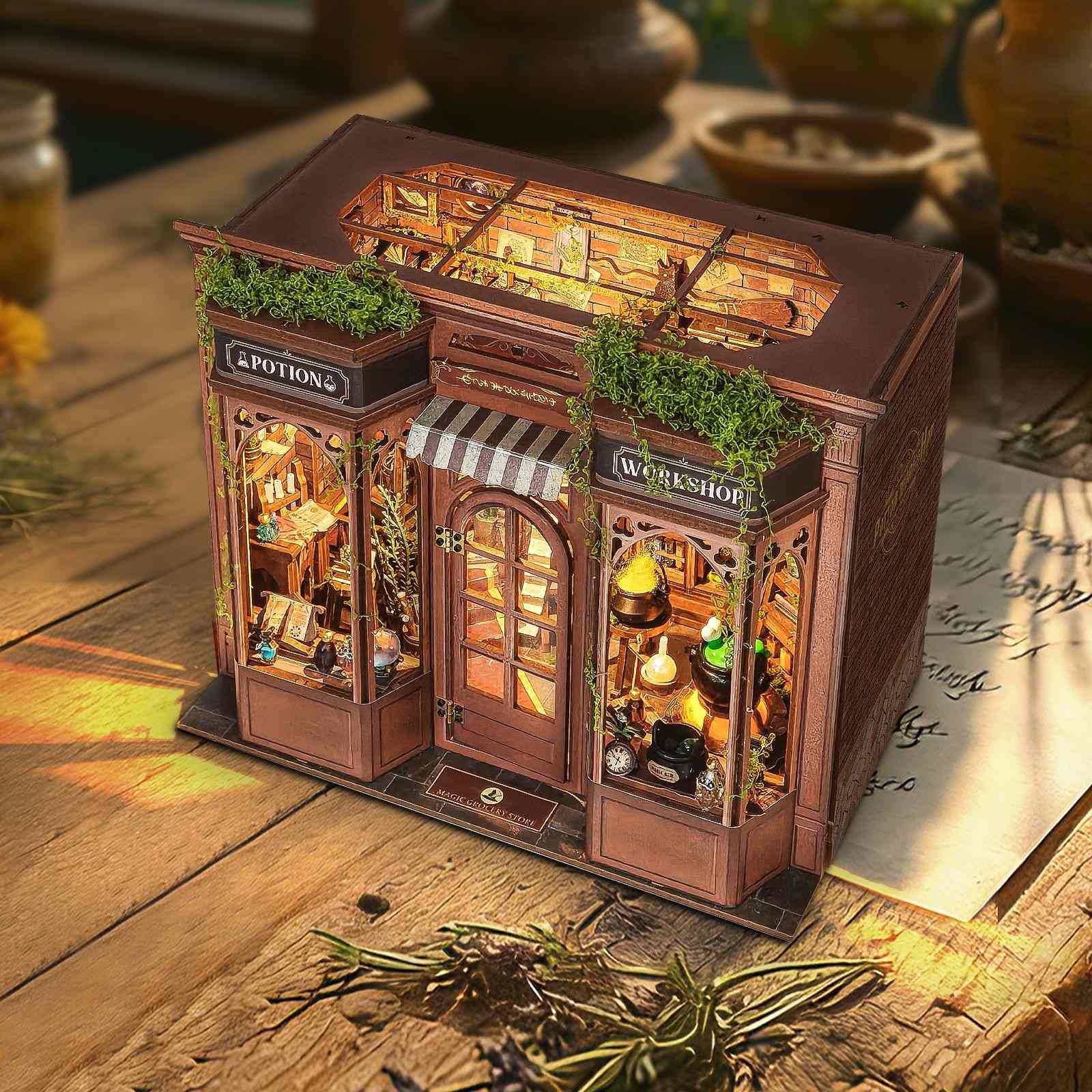 Miniature model of a magical shop with glowing interior on a wooden surface.
