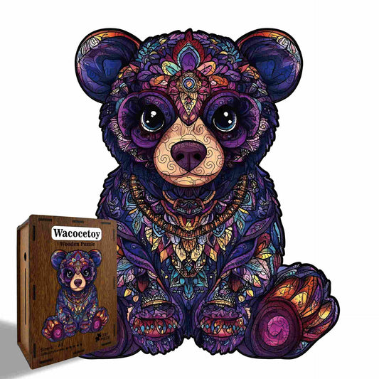 Colorful teddy bear puzzle with intricate patterns next to its packaging on a white background