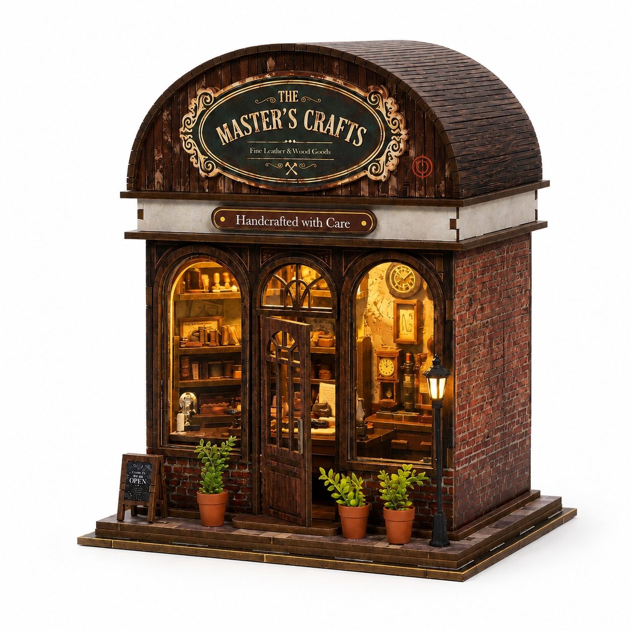 A miniature wooden model of 'The Master's Crafts' shop, featuring detailed brick and wood textures, warm glowing windows, potted plants, and a small chalkboard sign on a white background.
