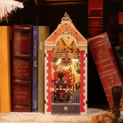 Decorative bookend shaped like a miniature house with a clock on a shelf with books.