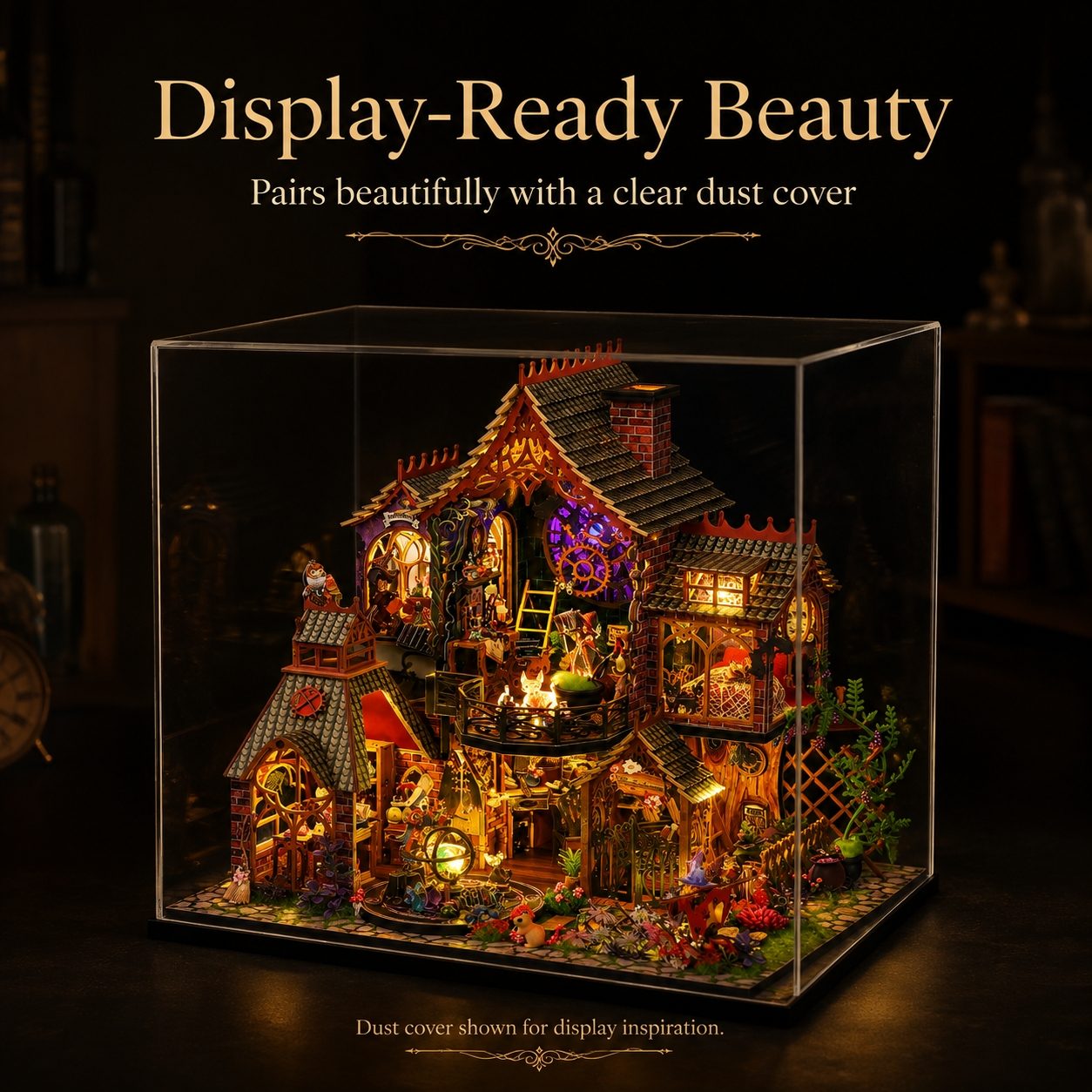 A miniature fantasy house display inside a clear acrylic dust cover, illuminated with warm LED lights. The scene includes tiny figures, plants, and decorative details, with text above reading 'Display-Ready Beauty' and text below noting the dust cover shown for display inspiration.
