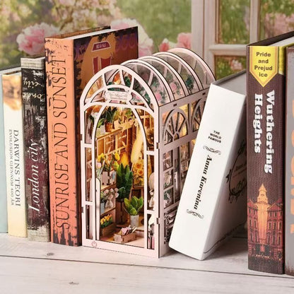 image displaying the finished Mini Greenhouse DIY Book Nook Kit in a bookshelf setting