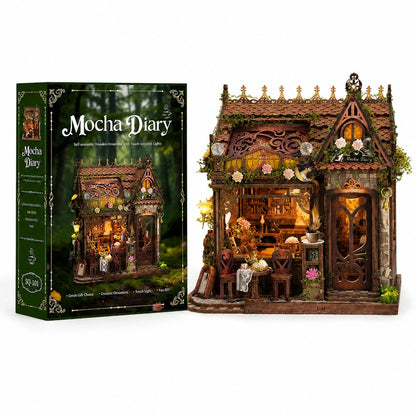 A Mocha Diary wooden miniature tea house kit shown next to its retail box on a white background. The box is dark green with an illustration of the completed tea house in a forest setting.