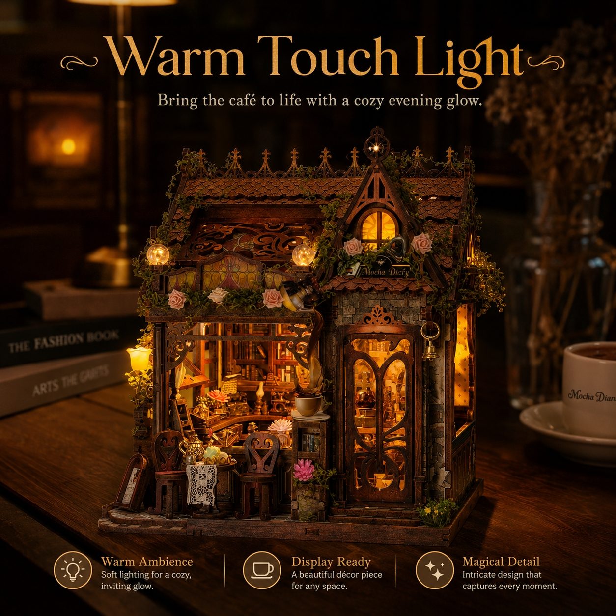 A miniature decorative cafe house night light with warm glowing lights and detailed interior, displayed on a wooden surface with cozy background props and promotional text.