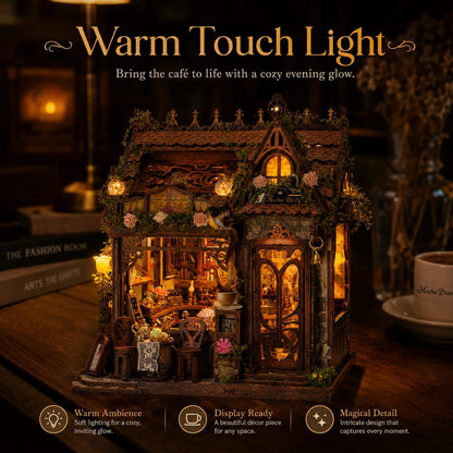A miniature decorative cafe house night light with warm glowing lights and detailed interior, displayed on a wooden surface with cozy background props and promotional text.