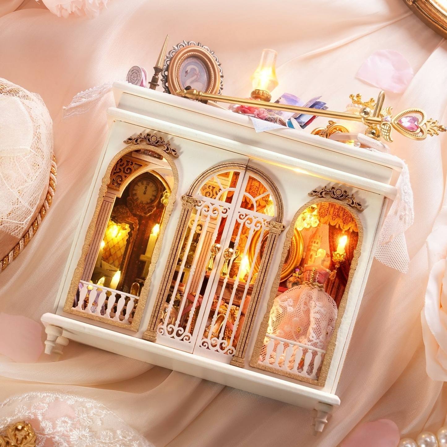 Decorative miniature scene with intricate details on a soft pink background