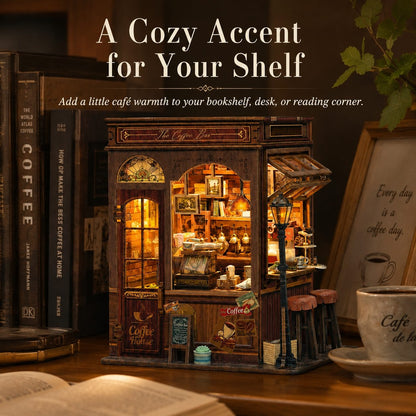A miniature coffee shop shelf decor piece displayed on a wooden shelf next to books, with text overlay reading 'A Cozy Accent for Your Shelf'.