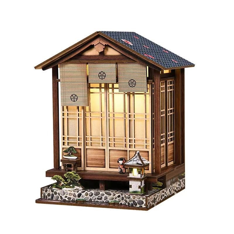 Miniature House Model of a traditional Japanese house with wooden architecture and decorative elements on a white background