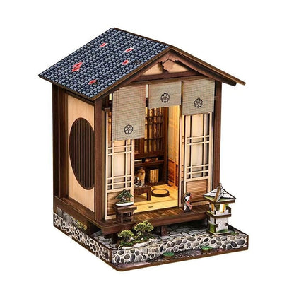Miniature model of a traditional Japanese house with detailed interior and exterior.