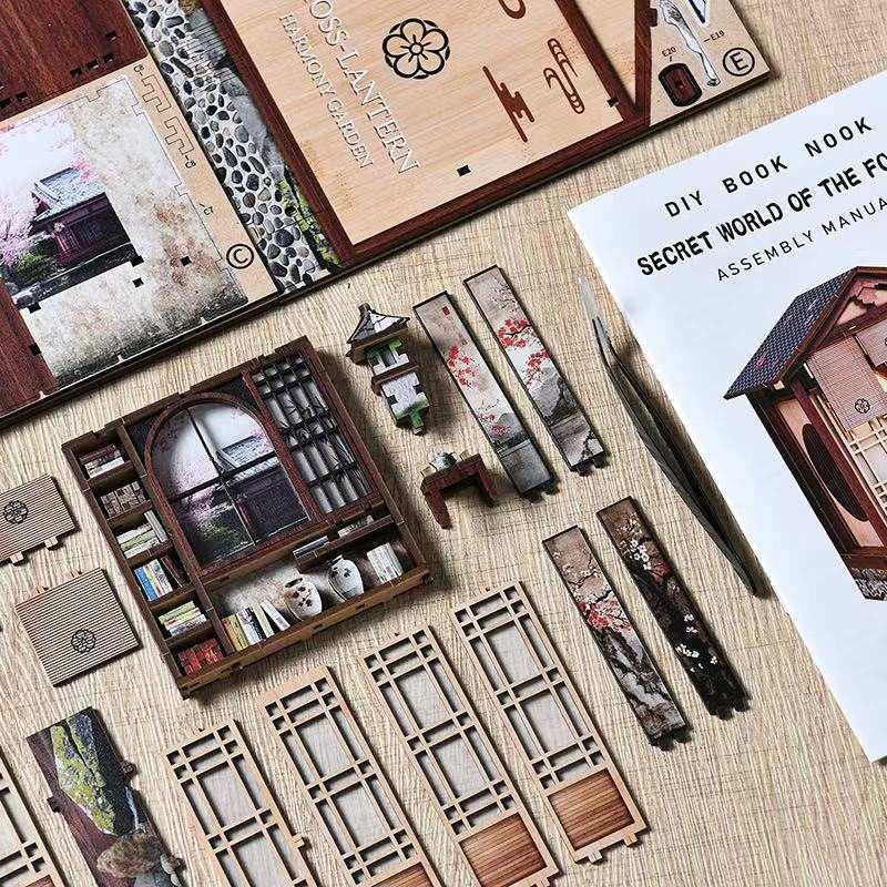 Wooden model building kit with components and assembly manual on a textured surface